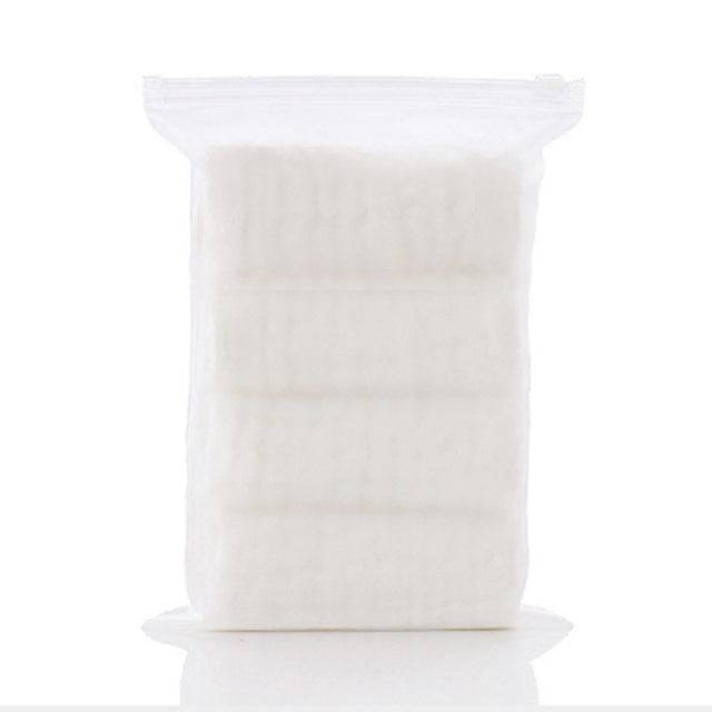 a bag of white cotton sitting on top of a white table