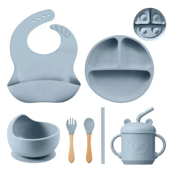 a set of baby feeding utensils and dishes