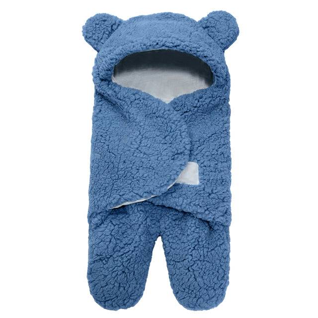 a blue teddy bear sleeping bag on a white background