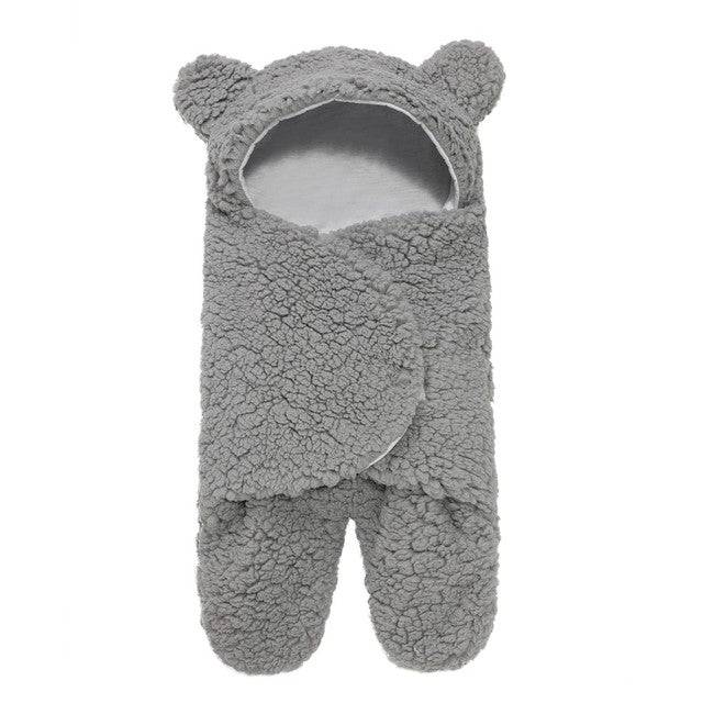 a pair of grey bear slippers on a white background