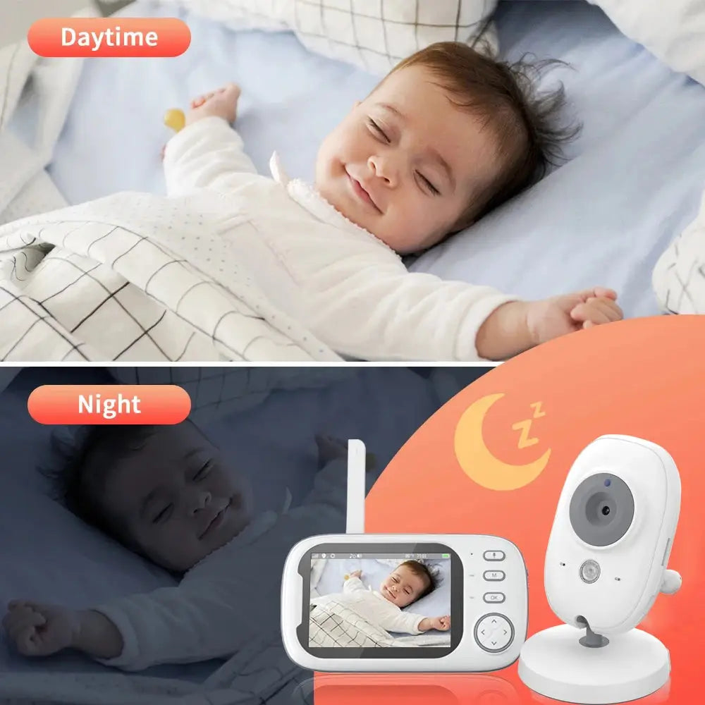 a baby laying on a bed next to a baby monitor