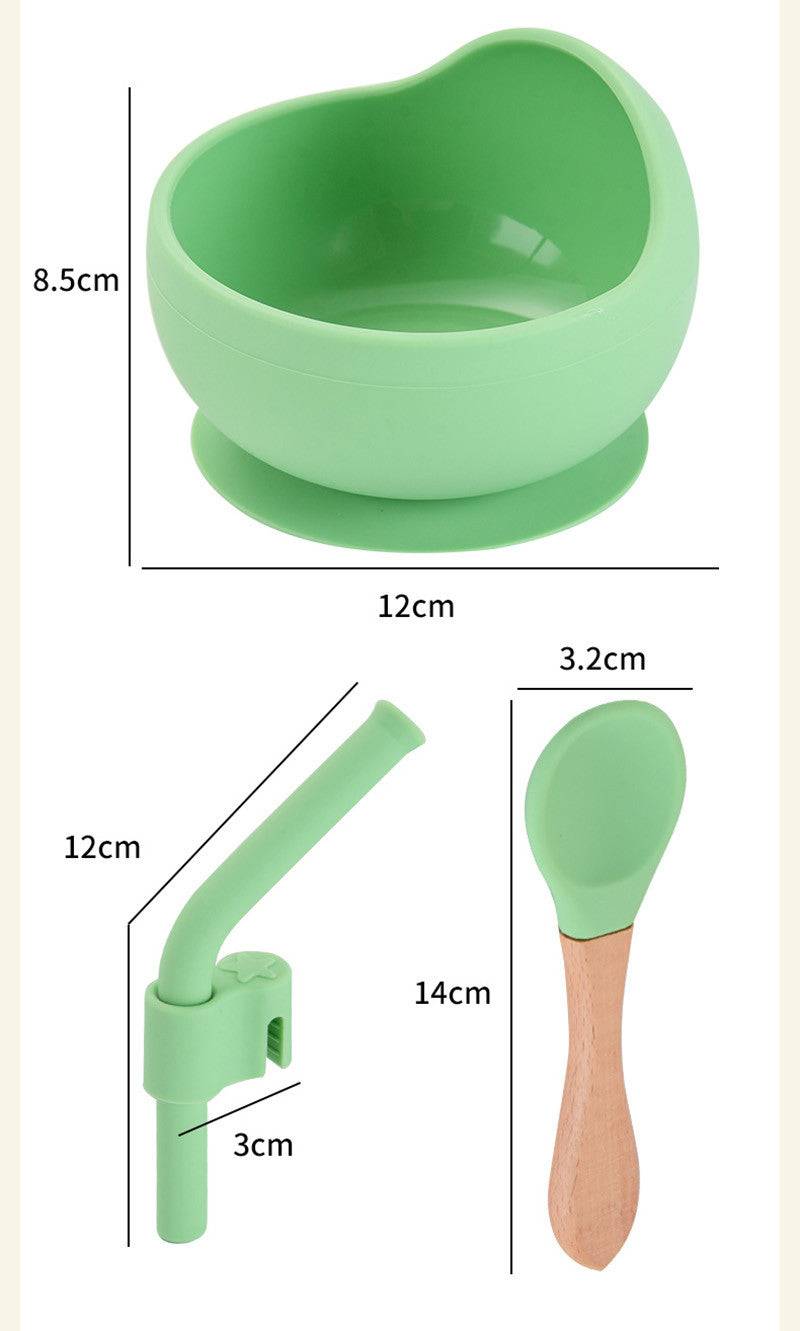 a green bowl with a wooden spoon next to it