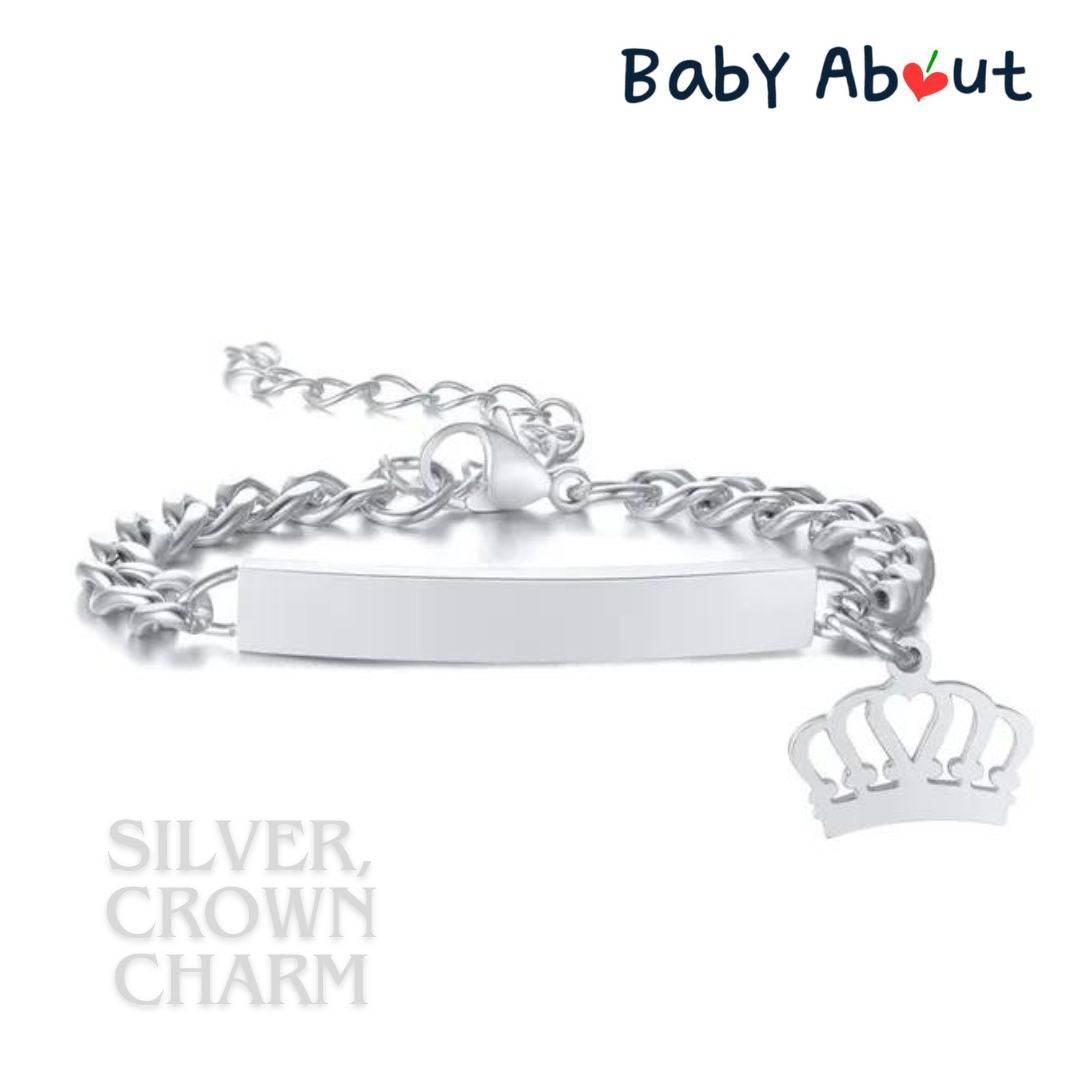 a silver chain bracelet with a crown charm