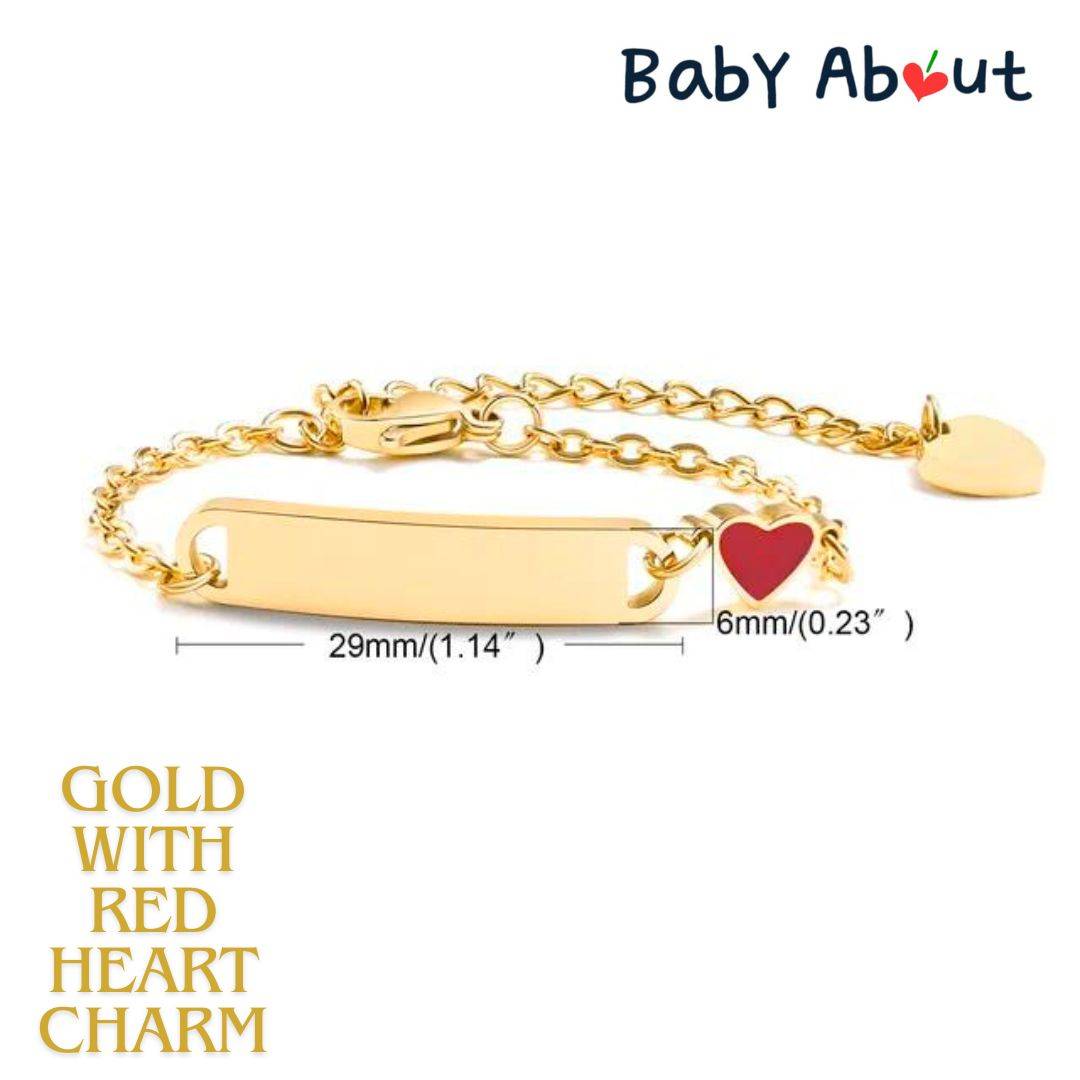 a gold bracelet with a red heart charm