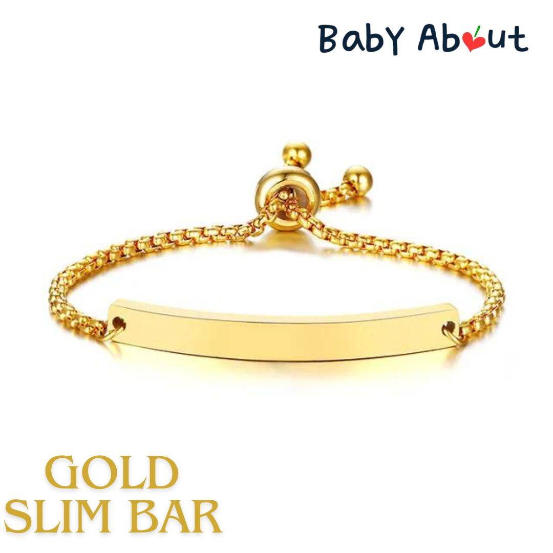 a gold bracelet with a bar on it