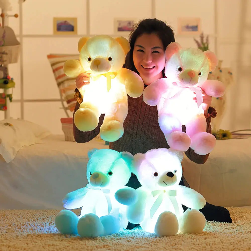 a woman sitting on the floor with a bunch of stuffed animals