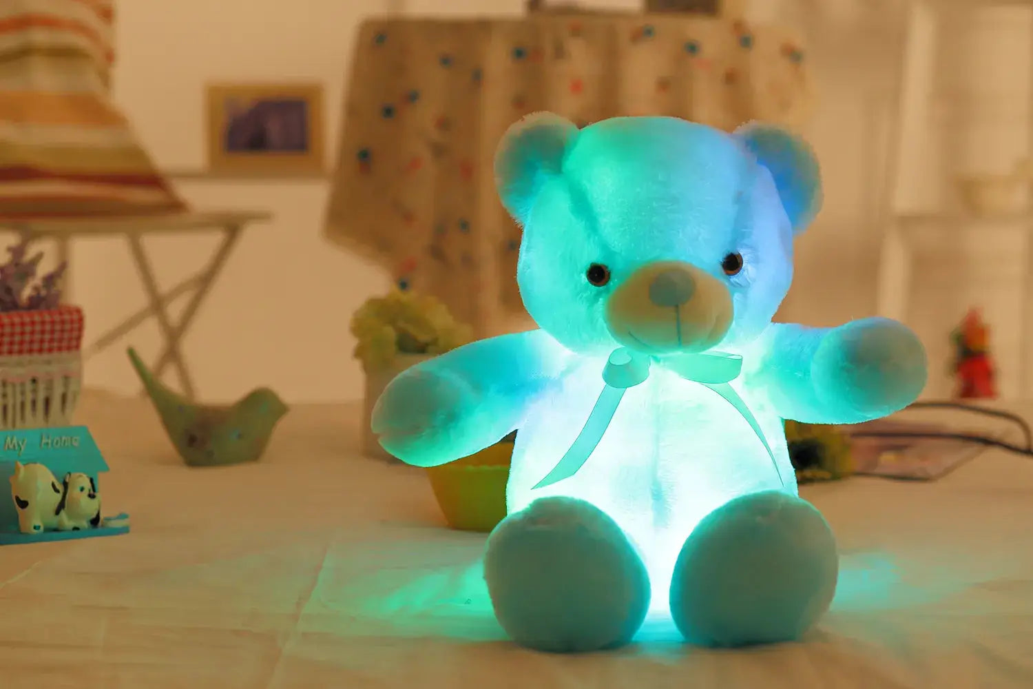 a blue teddy bear sitting on top of a table