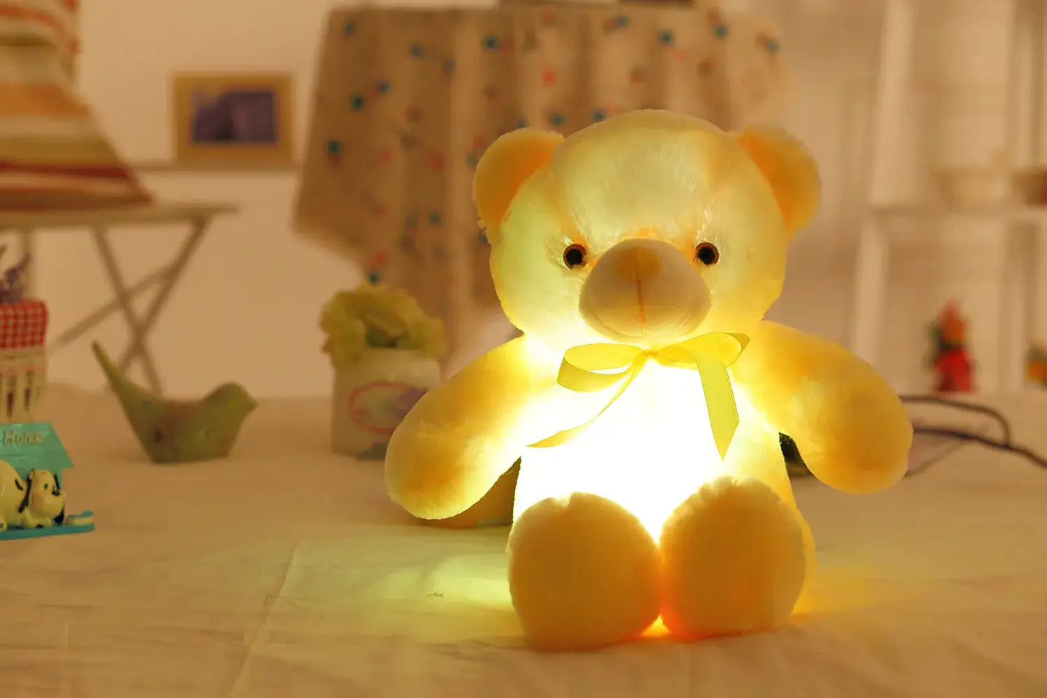 a yellow teddy bear sitting on top of a table