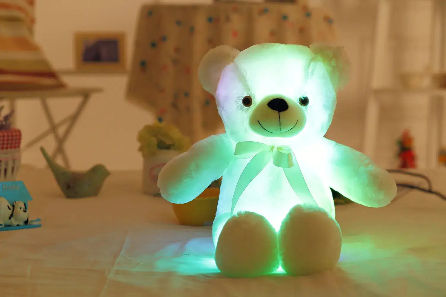a white teddy bear sitting on top of a table