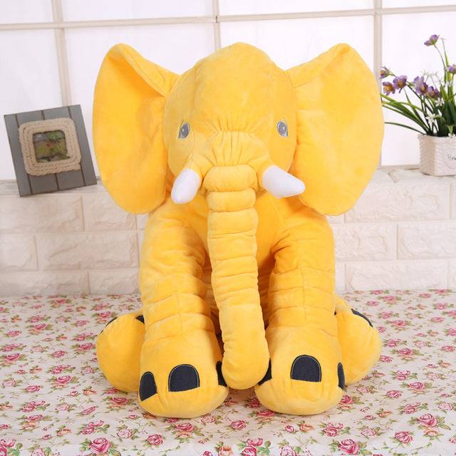 a large stuffed elephant sitting on a table