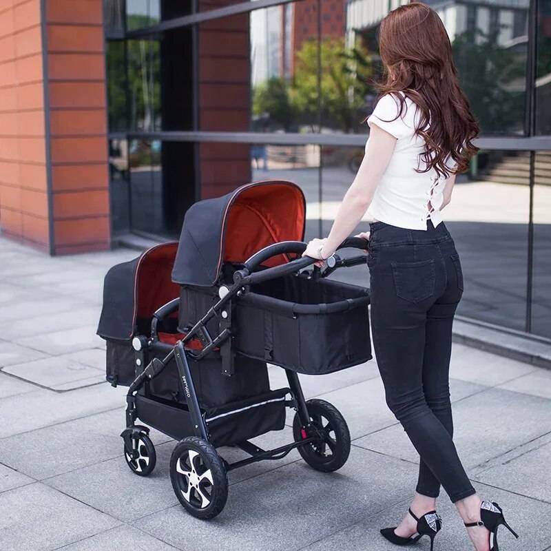 a woman pushing a stroller with a baby in it