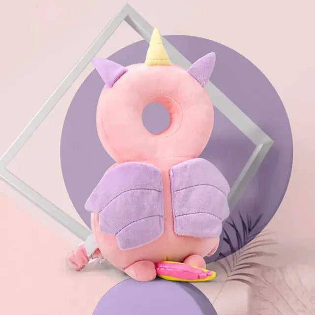 a pink stuffed animal with a unicorn horn