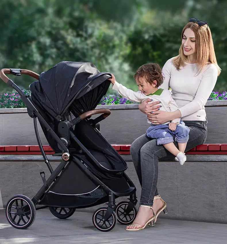 a woman sitting on a bench next to a baby in a stroller