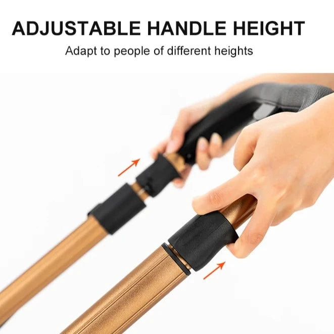 a hand holding a wooden cane with a black handle