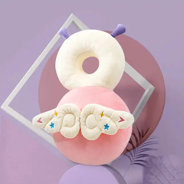 a pink doughnut with wings on top of it