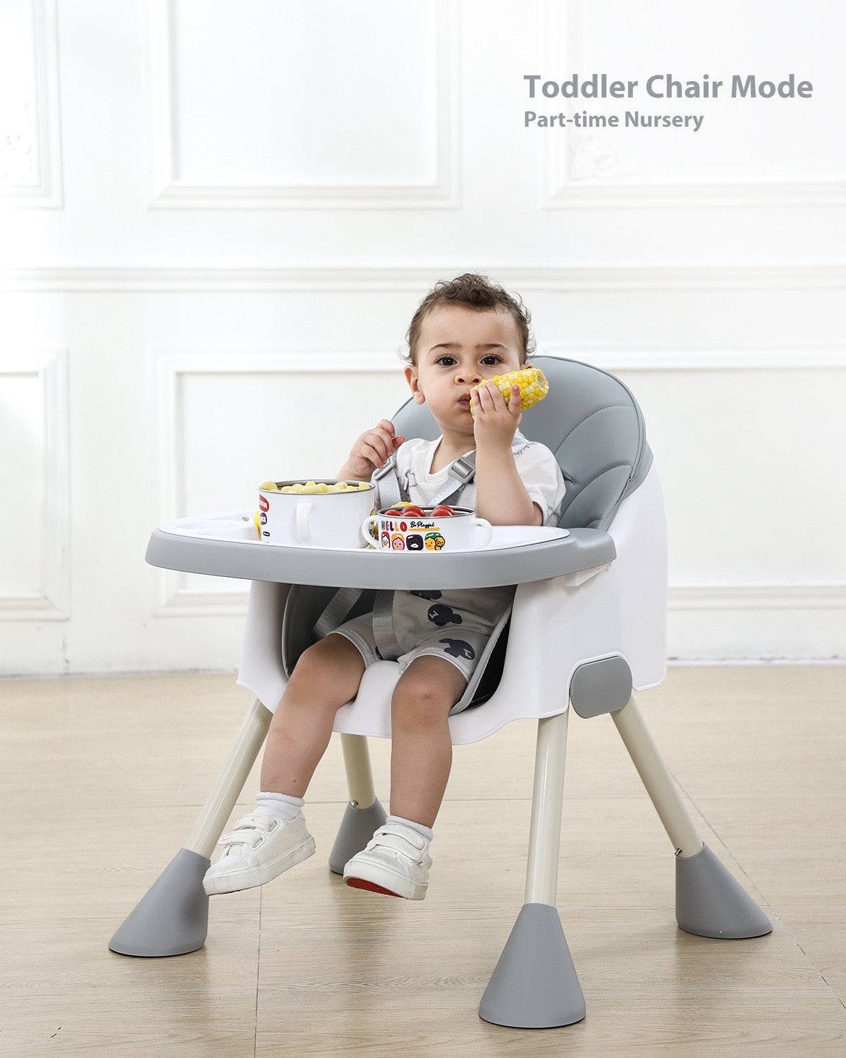 a little boy sitting in a high chair eating food