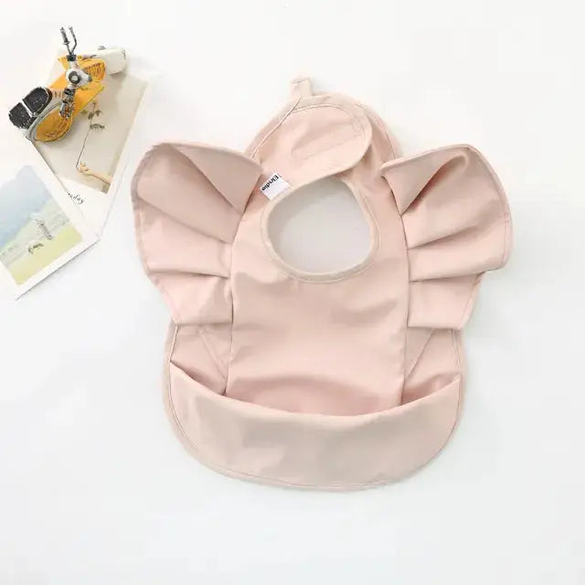 a pink bib with a hole in the middle