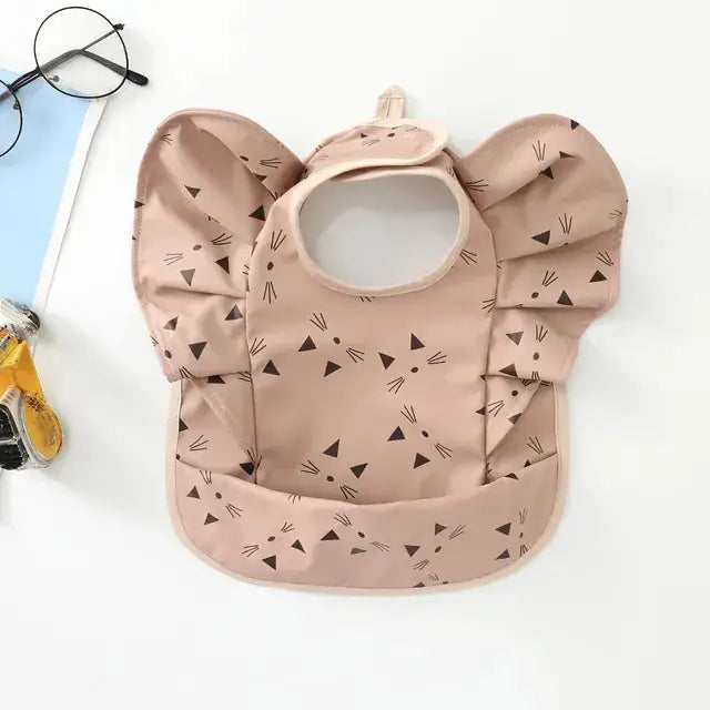 a baby bib with a pair of glasses next to it